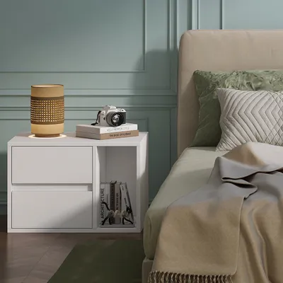 A bedroom scene with a nightstand next to a bed.