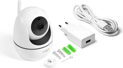 A white Technaxx FullHD TX-146 PT IP surveillance camera for indoor use is shown with its accessories, including a power adapter, USB cable, and mounting hardware, on a white background.