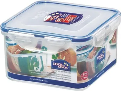 A Lock & Lock square food container is shown from a slightly elevated front-diagonal angle against a white background. The container is clear with a blue lid and blue locking clasps. The lid has a label with the Lock & Lock logo and product information. Th