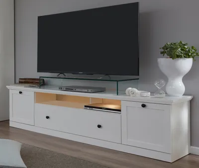A modern living room TV console with a large flat-screen television.