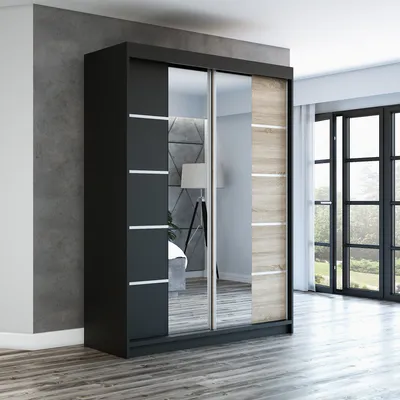 A modern sliding door wardrobe with a mirrored front, placed in a room with a concrete wall and wooden floor.