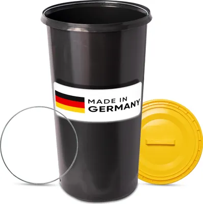 A black trash can with a yellow lid and a "Made in Germany" label.