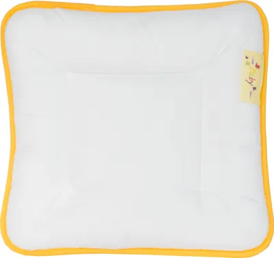 A flat baby pillow with a yellow border and a small yellow tag with text and graphics.