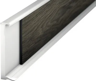 A close-up, angled view of a white PVC skirting board with a dark wood-effect insert, set against a white background.