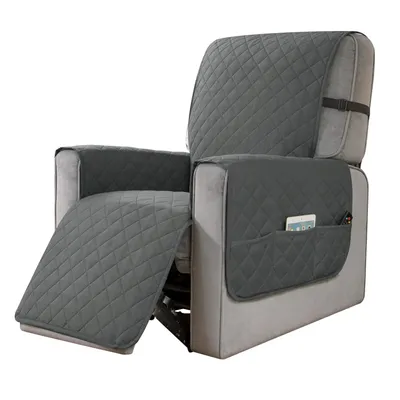 A gray recliner chair with a protective cover, showing the footrest extended and side pockets with a phone and remote.