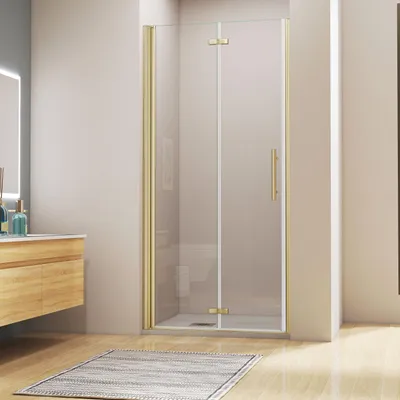 A modern bathroom with a gold-framed shower enclosure.