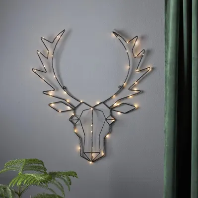 A wireframe deer head with LED lights mounted on a wall.