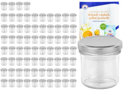 A set of small glass jars with silver lids and a recipe booklet.