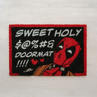 A doormat with Deadpool on it, placed on a light-colored wooden floor.