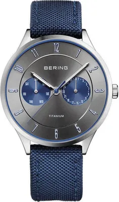 A close-up studio shot of a Bering men's watch with a gray dial and blue accents.