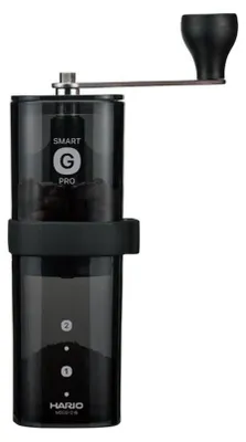 A black and transparent manual coffee grinder on a white background.