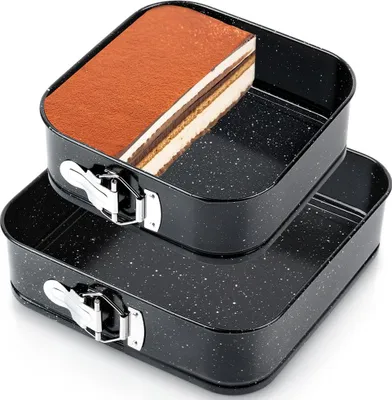 Two square springform pans, one stacked on top of the other, with a slice of tiramisu cake in the top pan.