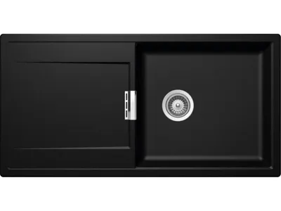 A black kitchen sink with a drainer and a silver drain fitting.
