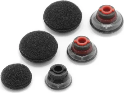 A collection of black foam earbud tips and clear/red silicone earbud tips arranged on a white background.