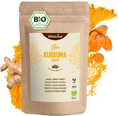 A bag of turmeric powder with turmeric roots and slices.