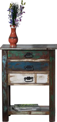 A vintage-style wooden side table with three drawers and an open shelf, decorated with a vase of flowers on top.