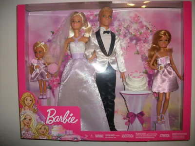 A Barbie wedding doll set in its original packaging, featuring Barbie, Ken, and two smaller dolls, along with wedding accessories.