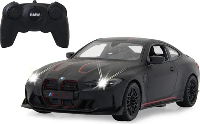 A black BMW M4 CSL toy car with red accents and a remote control.