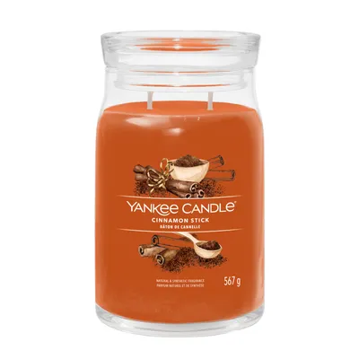 A Yankee Candle Cinnamon Stick scented candle in a glass jar with a lid.