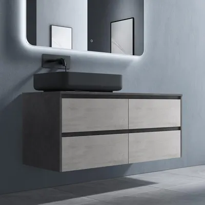 A modern bathroom vanity with a countertop sink and a backlit mirror.
