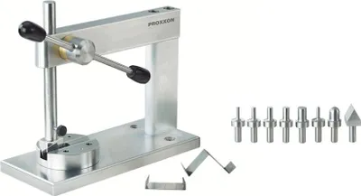 A metal micro-press machine with various attachments on a white background.