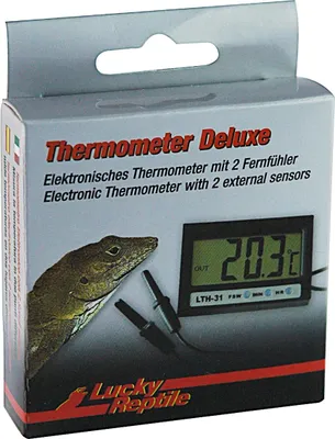 The image shows the packaging of a Lucky Reptile thermometer deluxe with a lizard illustration and a digital display showing the temperature.