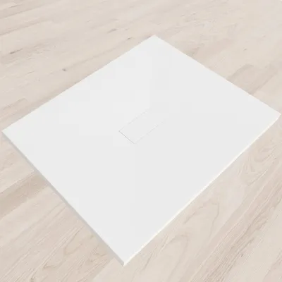 A white shower tray is placed on a light wooden floor.
