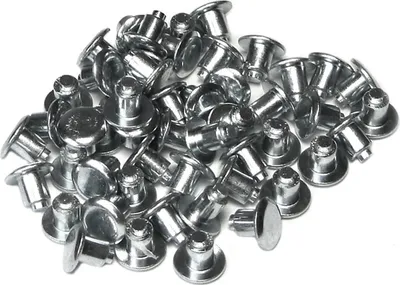 A pile of metal studs on a white background.