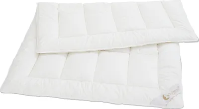 Two white duvets are stacked on top of each other against a white background.