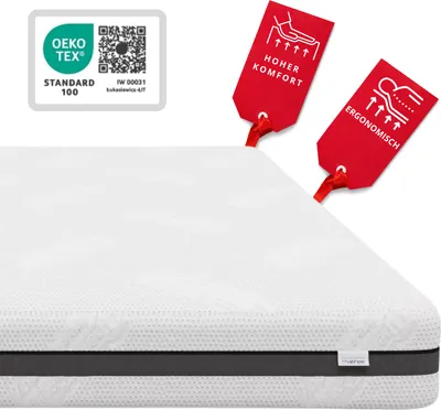 A white mattress with two red tags attached, one showing an illustration and the text "HOHER KOMFORT", and the other showing an illustration and the text "ERGONOMISCH". A white OEKO-TEX STANDARD 100 logo is also visible in the top left corner.