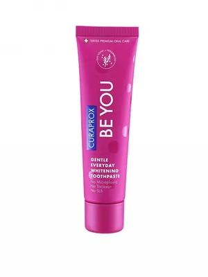 A pink tube of Curaprox toothpaste is shown against a white background.
