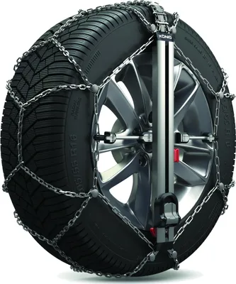 A snow chain is fitted to a car tire.