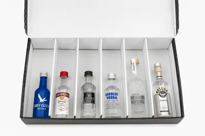 A tasting box containing six miniature bottles of different vodkas.