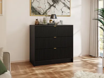 A modern black dresser in a well-lit room.