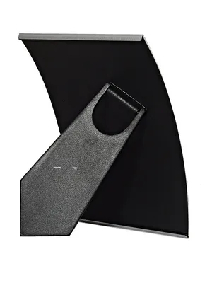 The back of a silver picture frame with its stand extended.