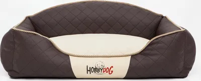 A brown and cream quilted dog bed with the brand logo visible.