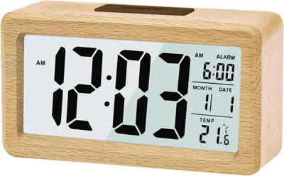 A digital alarm clock with a wood-look casing is displayed against a white background.