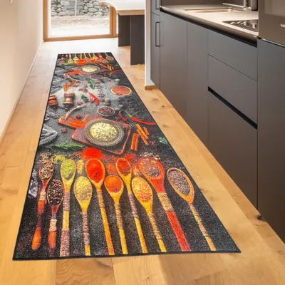 A kitchen runner rug with a spice pattern is laid out on a wooden floor in a modern kitchen.