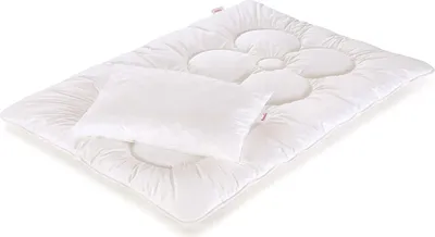 A white duvet and pillow set for a child's bed, with a flower-shaped quilting pattern on the duvet.
