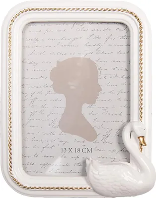 A white picture frame with a swan decoration and a silhouette of a woman's head inside.