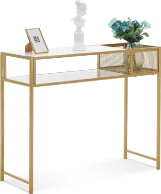 A narrow console table with a marble top and gold metal frame, decorated with a framed picture, a bust, and a vase of blue flowers.