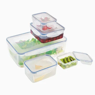 A set of clear plastic food storage containers with blue lids, some containing food items like salad, cherries, and kiwi slices.