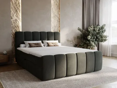 A modern bedroom with a dark gray upholstered boxspring bed.
