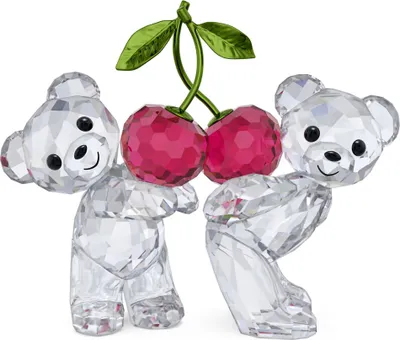 Two crystal teddy bears holding a pair of crystal cherries.