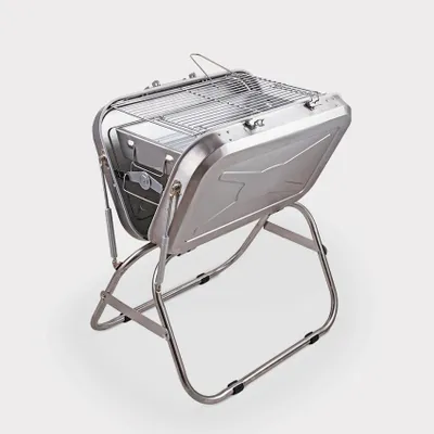 A portable charcoal grill is shown on a light gray background.