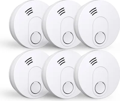 A set of six white smoke detectors arranged in two rows of three.