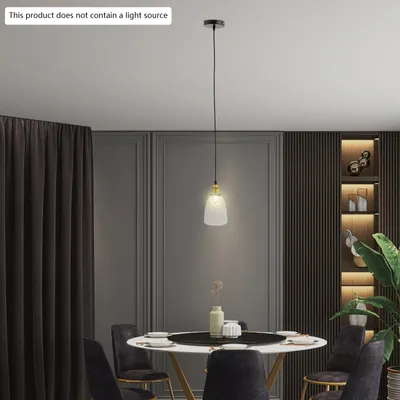 A dining room setting with a pendant light over a table.