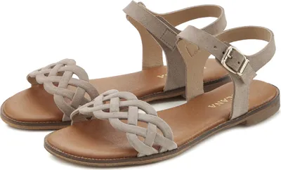 A pair of beige flat sandals shown from a diagonal angle on a white background.