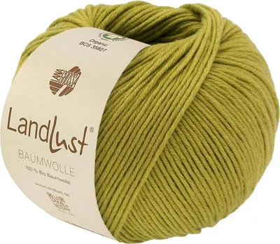 A ball of green yarn with a beige label wrapped around it.