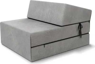 A folded futon sofa/mattress is shown in a studio setting.